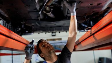 A mechanic working on exhaust maintenance for optimal performance of a car